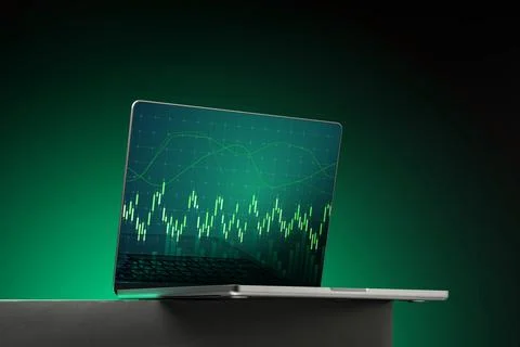 Laptop displays financial data analysis with green background and graph on Stock Photos