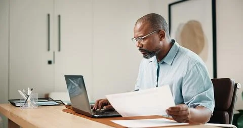 Laptop, document and black man in home office with remote work, admin or re.. 스톡 사진