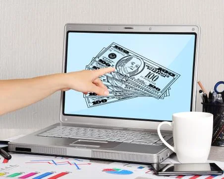 Laptop with dollars Stock Photos