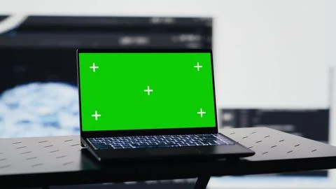 Laptop in empty space shows copy space screen surrounded by data Stock Photos
