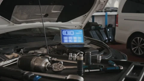 Laptop with Engine Diagnostics Program and Wrench on Tool Cart in Auto Garage Vídeo Stock 329405307