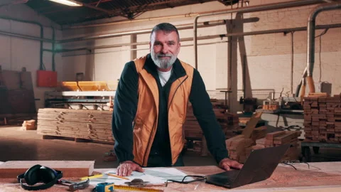 Laptop, face and man in workshop for carpentry, manufacturing and furniture Stock Footage 338046366