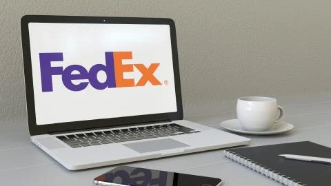 Laptop with FedEx logo on the screen. Modern workplace conceptual editorial 3D Stock Illustration