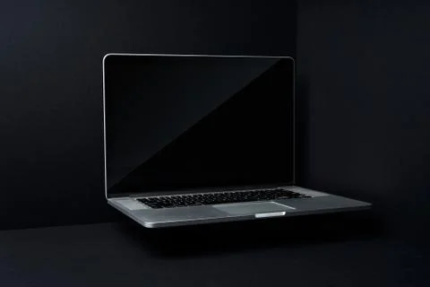 Laptop floating on mockup three dimensional black background Stock Photos