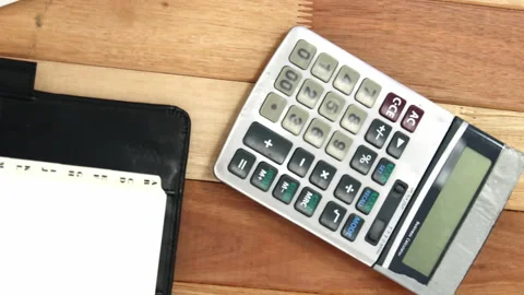 Laptop with folder, sticky note and calculator Stock Footage 301037408
