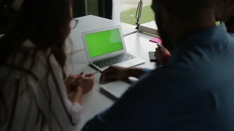 Laptop with green blank screen on table. Video stock 105421600