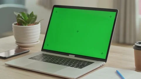 Laptop With Green Mock-Up Screen On The Table, Video In 4K Stock Footage 153104799