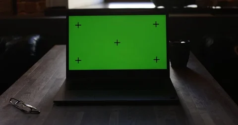 Laptop with green screen and Tracking Dot. Dark office. Dolly in. Perfect to put Stock Footage 127001455