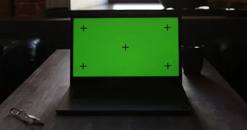 Laptop With Green Screen and Tracking Dot. Dark office. A Man's Hand Opens The 스톡 동영상 136055179