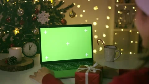 Laptop with green screen. Computer with chroma key on table, burning candle a Video stock 220951373
