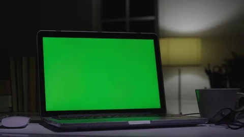 Laptop with green screen. Dark office. Video stock 107458649