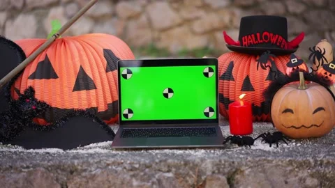 A laptop with a green screen with dots for tracking movement against the Stock Footage 219756044