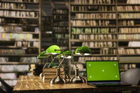 Laptop with green screen on empty library table for education mockup Stockfoto's
