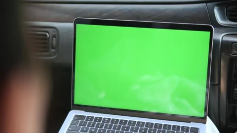 Laptop with green screen inside car, used for video editing 動画素材 343849690