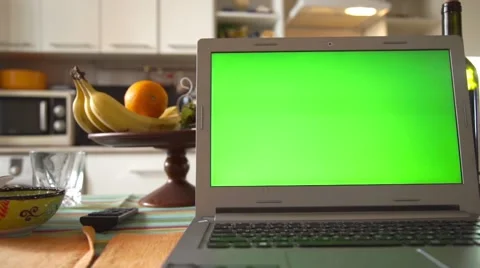 Laptop with green screen on the kitchen table Stock Footage 62296221