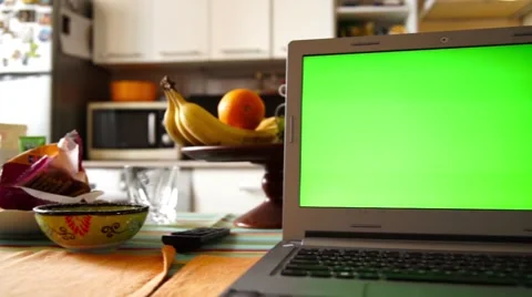 Laptop with green screen on the kitchen table Stock Footage 62297652