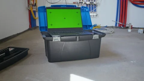 Laptop with Green Screen Mockup Sitting on Toolbox in Utility Room Stock Footage 340611298