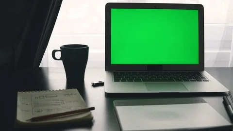Laptop with green screen. Programmer's workplace Stockbeeldmateriaal 87879363