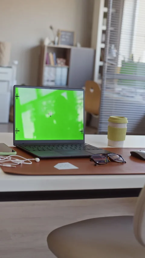 Laptop with Green Screen Sitting on Office Desk in Vertical Shot Stock Footage 341563719