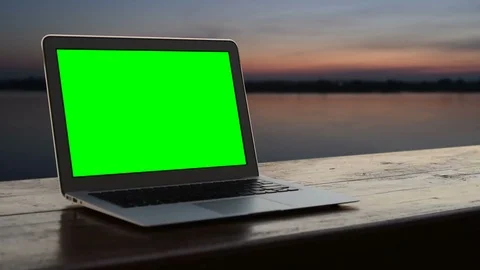 Laptop green screen with sunset. Stockbeeldmateriaal 95411406