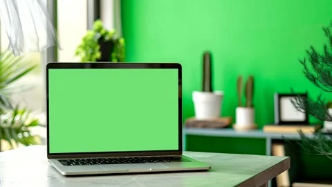Laptop with Green Screen on Table in Green Room with Plants Stock Footage 297640925