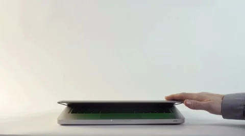 Laptop with a Green Screen on a White Backdrop Stock Footage 60688366