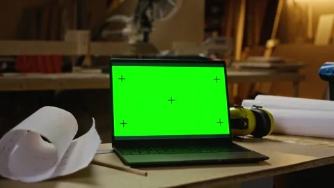 Laptop with Green Screen on Workbench in Carpentry Workshop Stock Footage 340391996