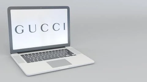 Laptop with Gucci logo. Computer technology conceptual editorial 3D rendering Illustrazione stock