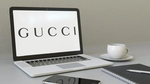 Laptop with Gucci logo on the screen. Modern workplace conceptual editorial 3D Stock Illustration