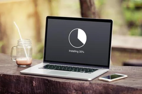 Laptop with installing update with circle load percentage waiting indicator  Stock Photos