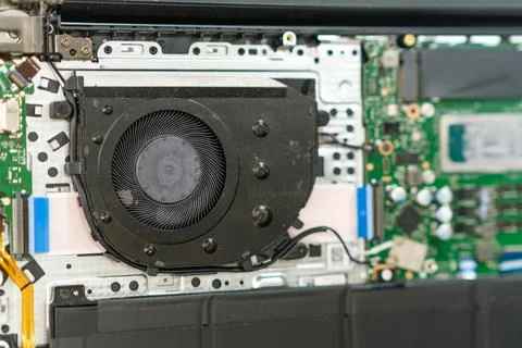 Laptop internal components with cooling fan and circuit board visible Stock Photos