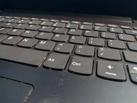 A laptop keyboard is a compact, integrated input device, containing buttons.. Stock Photos