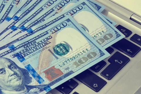 Laptop keyboard with dollars 写真素材