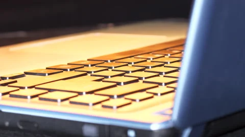 Laptop keyboard illuminated by changing timed light Stock Footage 151222954