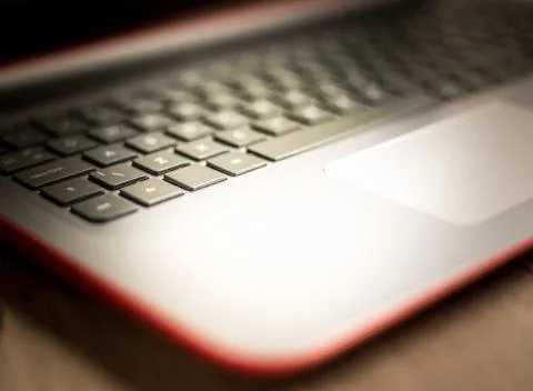 Laptop keyboard with selective focus on the keys and a soft and warm backgrou Stock Photos