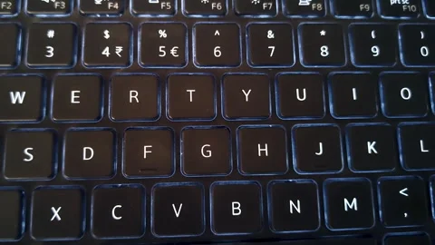 Laptop keyboard typing close up low light tech work coding workspace Stock Footage 333498137