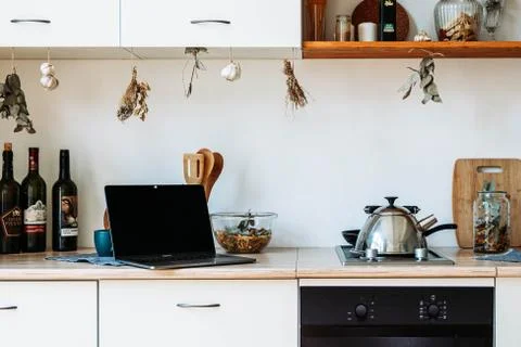 Laptop on the light kitchen Stock Photos