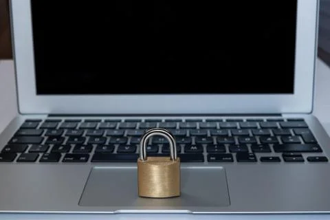 A laptop with a lock in front as a concept of web security Stock Photos