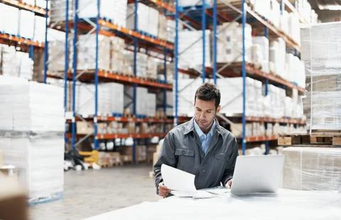 Laptop, logistics and documents with man in warehouse for delivery route Stock Photos