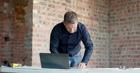 Laptop, man and writing on construction site for blueprint correction, drawing Stock Footage 337536341