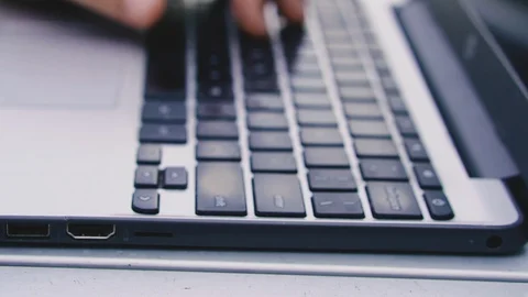 A laptop. Man's hands typing text on laptop keyboard. Stock Footage 121273845