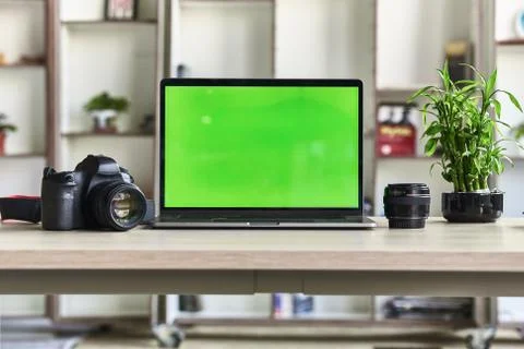 Laptop with mock-up green screen white background in office and Lovely plant  Stock Photos