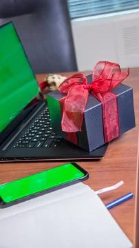 Laptop mock up grrn blank screen with gift box and phone with green screen on Stock Photos