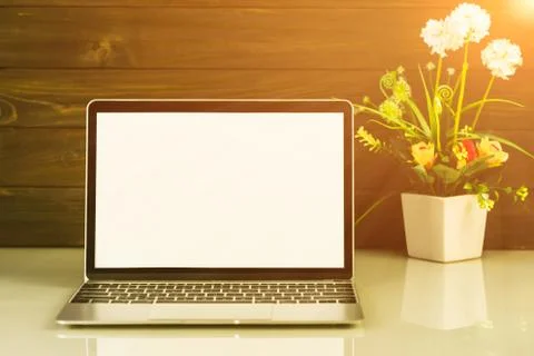 Laptop mockup with wood background on the work table Stock Photos