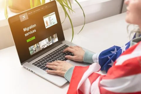 A laptop next to the USA flag. Flag of the United States close up. Concept - US Stock Photos
