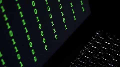 Laptop at night with changing binary code on the screen Stock Footage 71732274