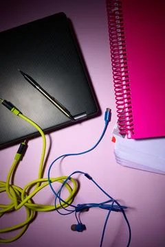 Laptop, notebook, data cables and pen on an office desk. 写真素材