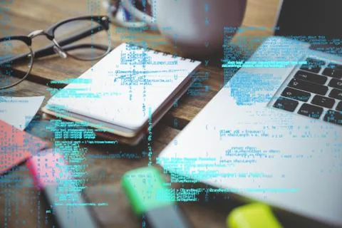 Laptop with notepad and coffee on table with graphics Stock Photos