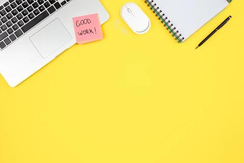 Laptop, notepad and paper reminder on yellow background, top view. Stock Photos
