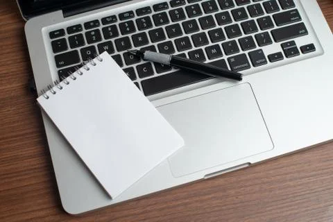 Laptop with notepad and pen Stock Photos